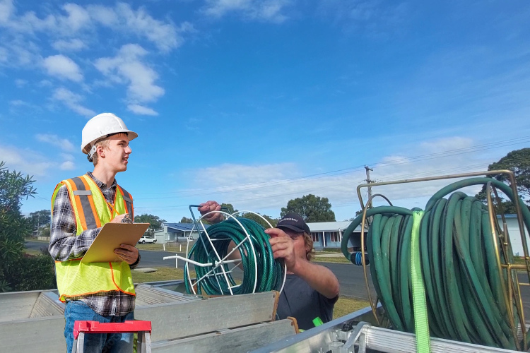 
portstephens gutter cleaning professional organizes hoses after thorough rinsing.