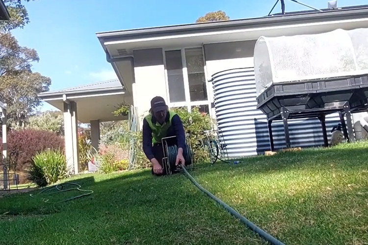 
As the sun sets, the portstephens downpipe cleaner is coiling his hose after a successful day.